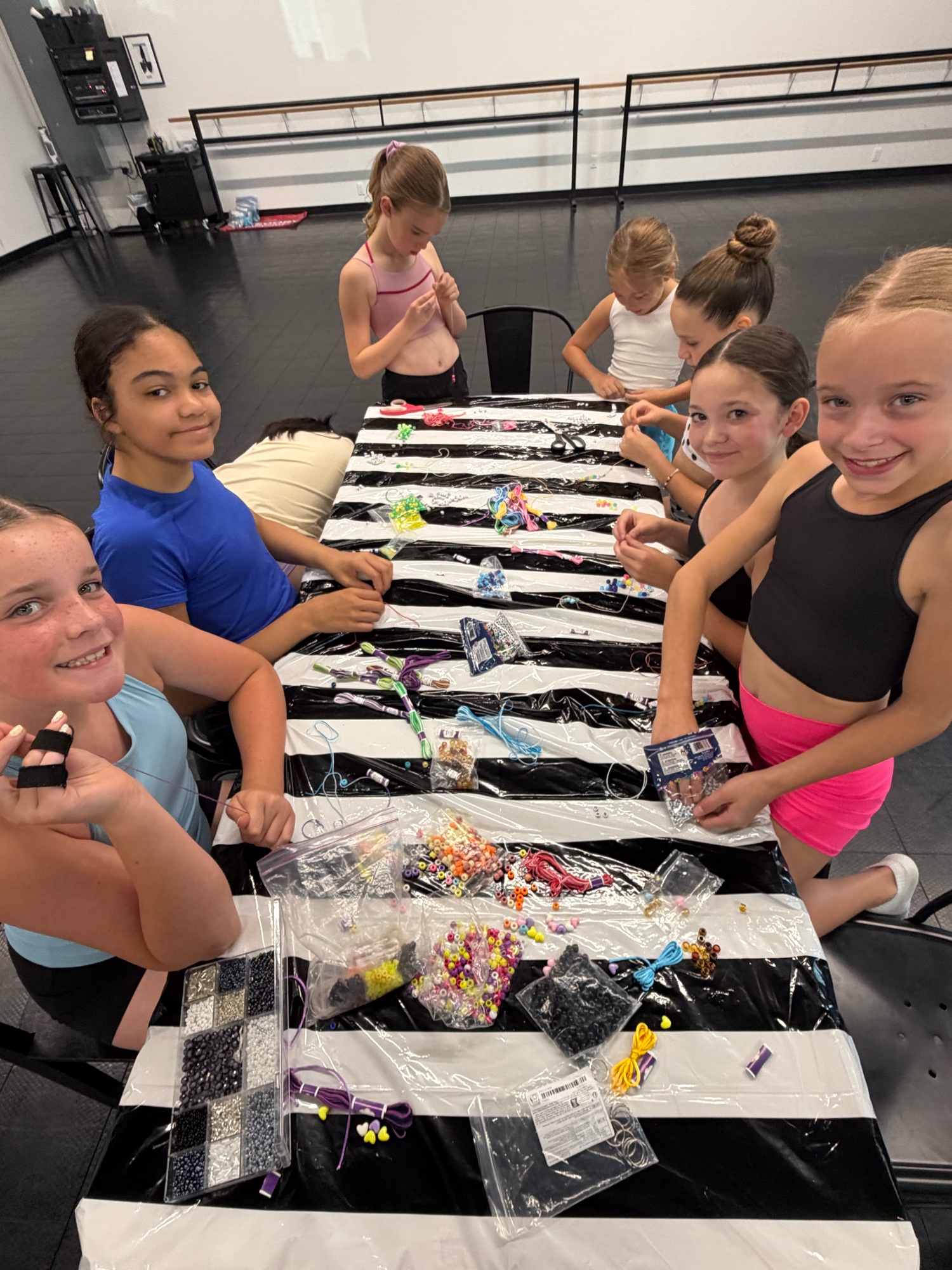 Danscott dancers making bead bracelets together at the studio